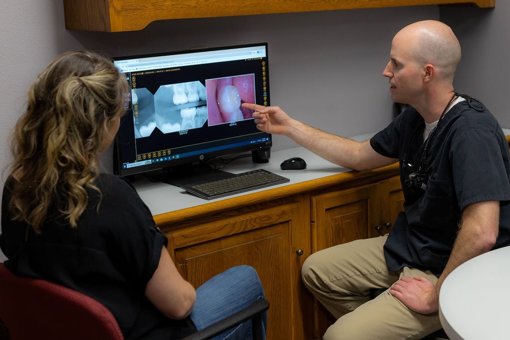 Dentist discussing treatment with a parent.